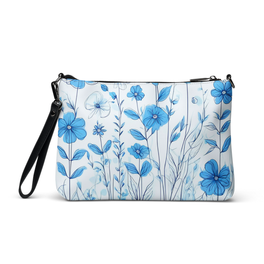 A chic crossbody bag featuring an all-over blue floral print on a white background—perfect for stylish everyday wear