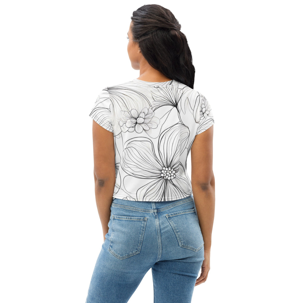 Back view of a white all-over print crop tee featuring bold outlined flowers, worn by a model with blue jeans—perfect for showcasing a stylish monochrome aesthetic