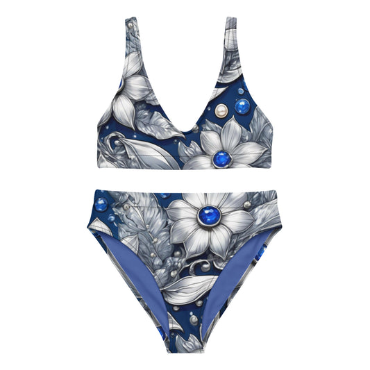An elegant high-waisted bikini set featuring a deep V-neck top and a floral design with large white flowers, leaves, and blue gemstones on a dark blue background—perfect for a stylish beach look
